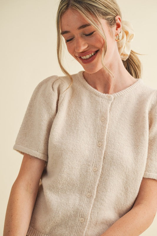 soft knit short sleeve cardigan, ivory knit button top, minimalist women’s sweater, boutique knitwear 2025, puff sleeve knit top, lightweight cardigan for women, elegant knit button tee, feminine minimalist clothing