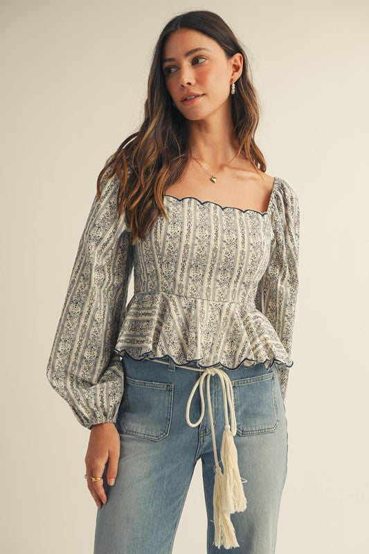 Amelie Floral Blouse – A romantic long sleeve peplum top featuring a square neckline and elegant floral print. Perfect for brunch, date night, or chic everyday styling. Shop now for timeless feminine style.