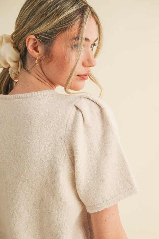 soft knit short sleeve cardigan, ivory knit button top, minimalist women’s sweater, boutique knitwear 2025, puff sleeve knit top, lightweight cardigan for women, elegant knit button tee, feminine minimalist clothing